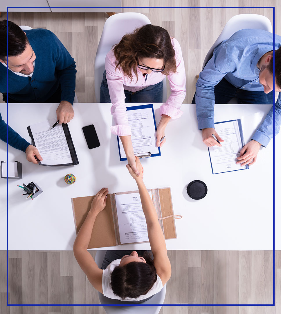 Top view of a desk with people working